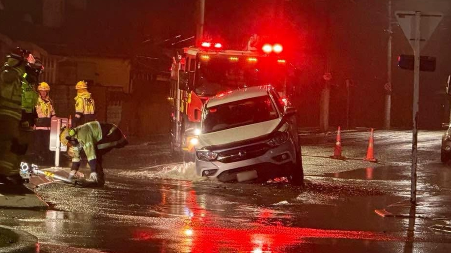 A ute stuck in a sinkhole that opened in a Dunedin street.